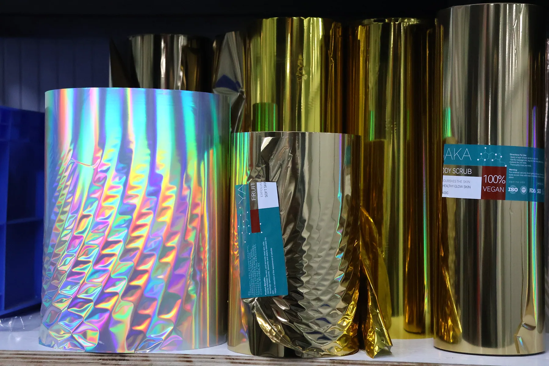 Flexible packaging material rolls with metallic, holographic, and printed finishes